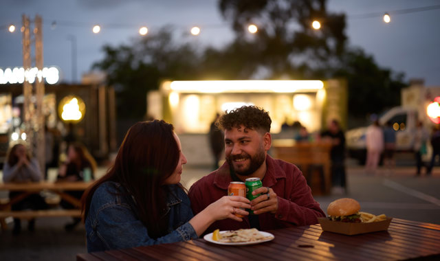 Woman and man enjoying a soft drink and some food at EverNow 2024